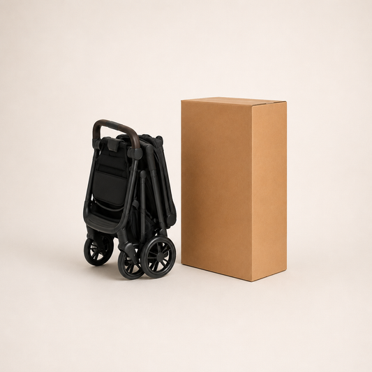 Compact folded pushchair shown beside a strong cardboard shipping box for moving, storage and delivery